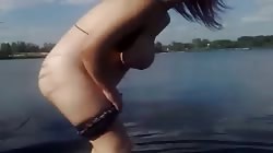 Spicy redhead amateur is posing topless in the river